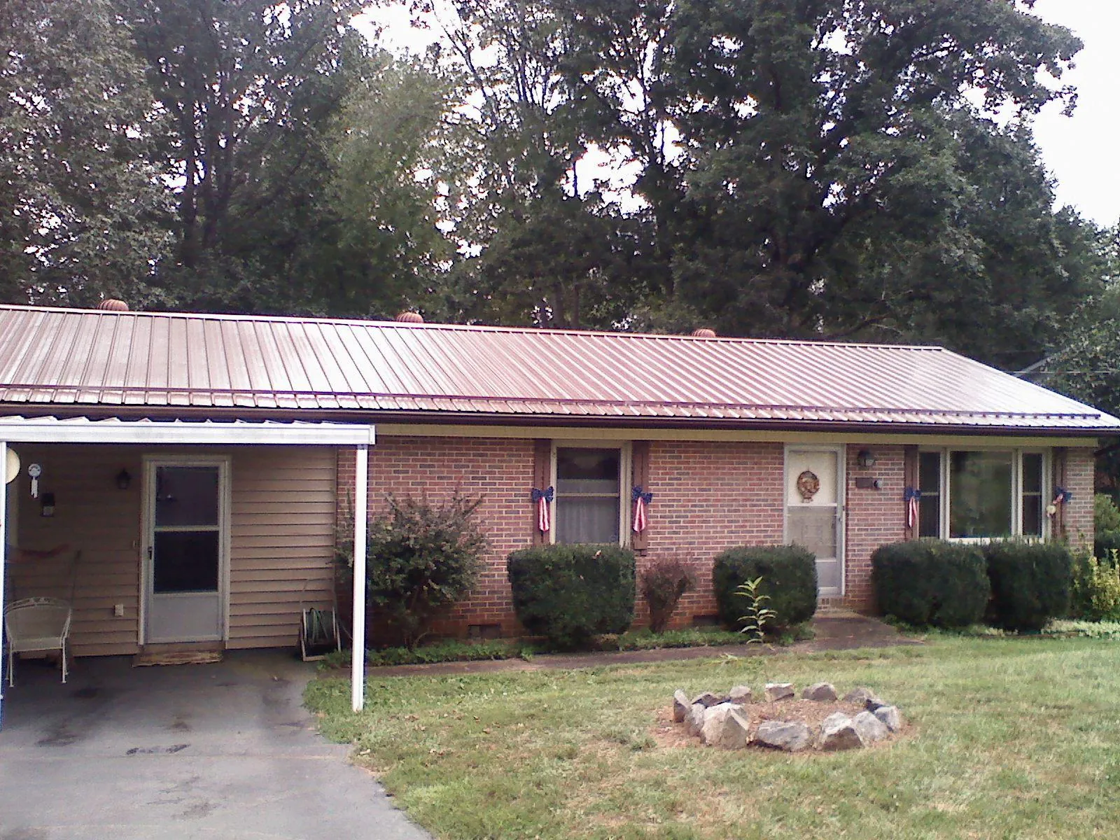Bronze metal roof and carport on a brick ranch home — Roof Repair work by our crew in Garden Grove